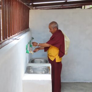 Lama priest trying out his new sanitation system